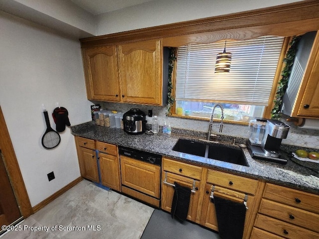 kitchen with dishwasher, brown cabinetry, and a sink