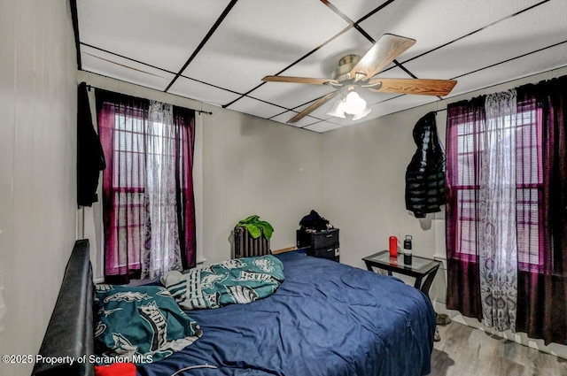 bedroom featuring ceiling fan and wood finished floors