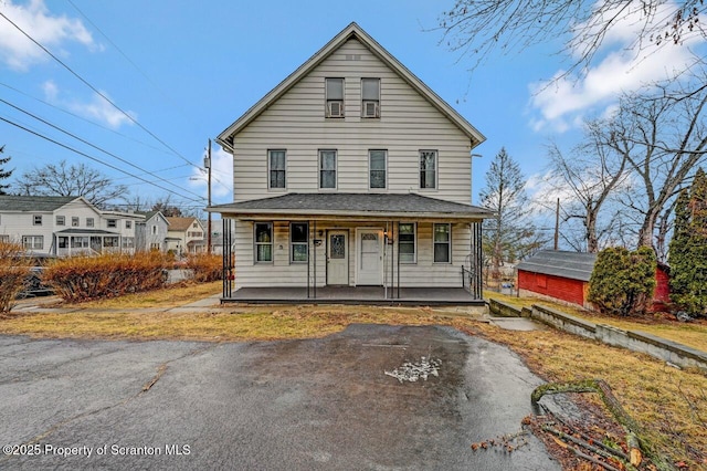 view of front of property with covered porch and a shingled roof