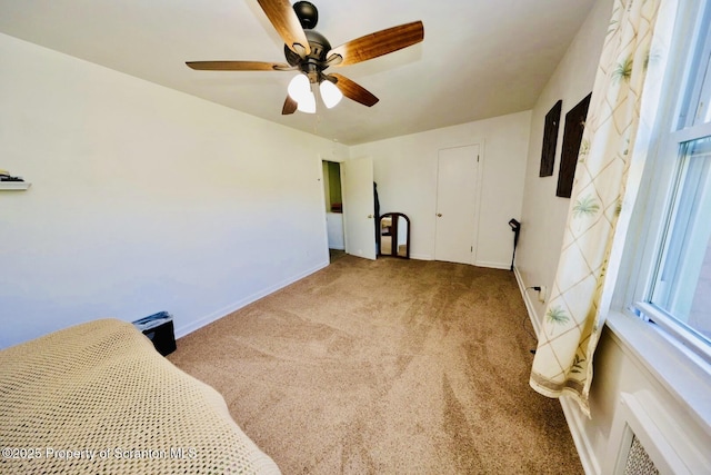 bedroom with carpet, baseboards, and ceiling fan