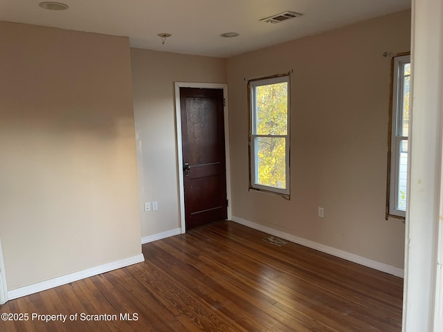 spare room featuring dark wood-type flooring