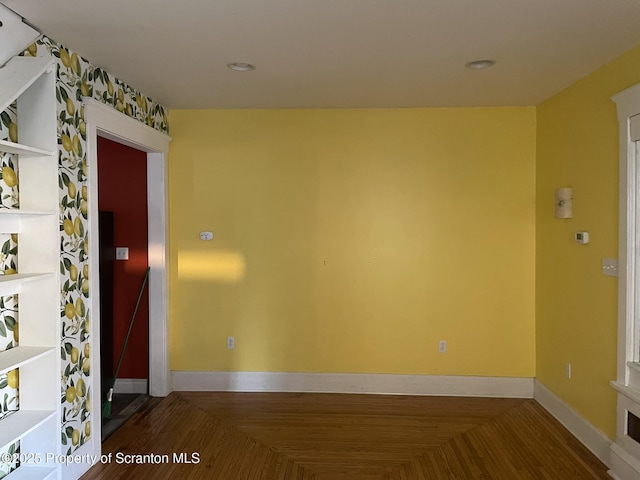 unfurnished room featuring parquet flooring