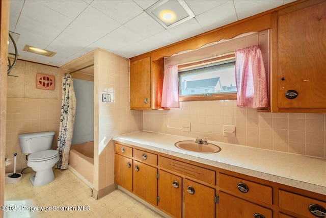 205 Lackawanna Ave, Duryea, PA 18642 - full bath featuring vanity, shower / bath combo with shower curtain, tile patterned floors, and decorative backsplash
