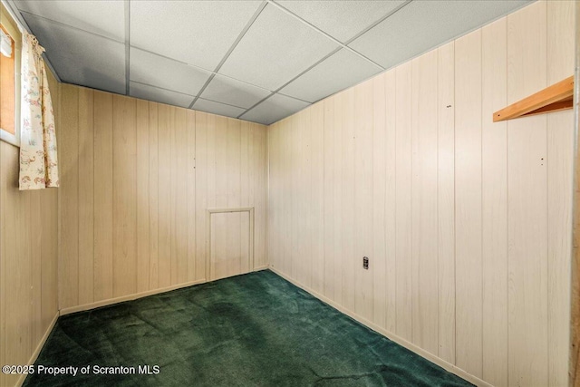 205 Lackawanna Ave, Duryea, PA 18642 - empty room featuring dark carpet, a drop ceiling, and wood walls