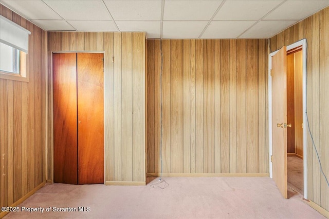 205 Lackawanna Ave, Duryea, PA 18642 - unfurnished bedroom with wood walls, a paneled ceiling, carpet, and a closet