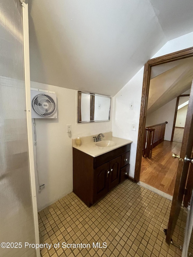 bathroom with lofted ceiling and vanity