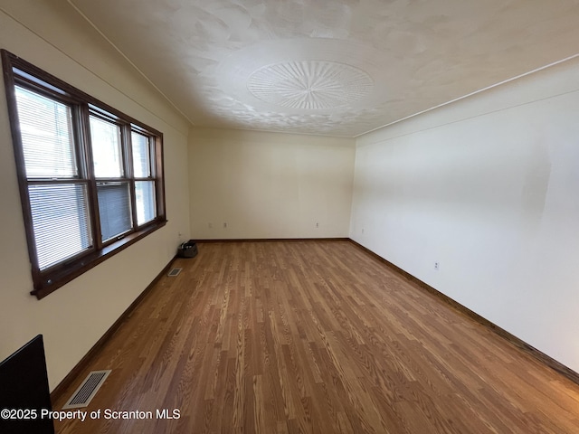 unfurnished room featuring hardwood / wood-style floors