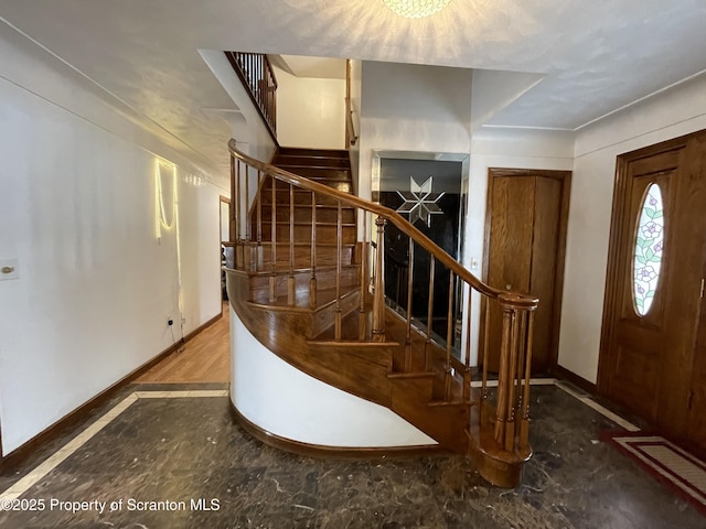 entryway with stairs and baseboards