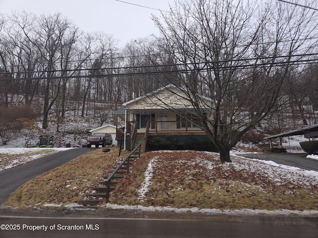 bungalow-style house with a porch and stairs