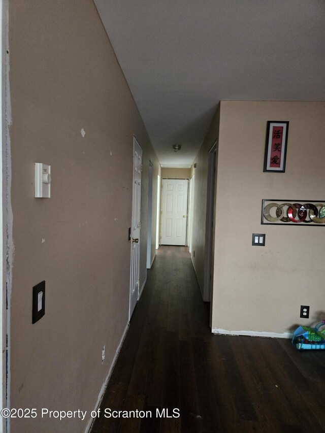 hall with baseboards and dark wood-style flooring