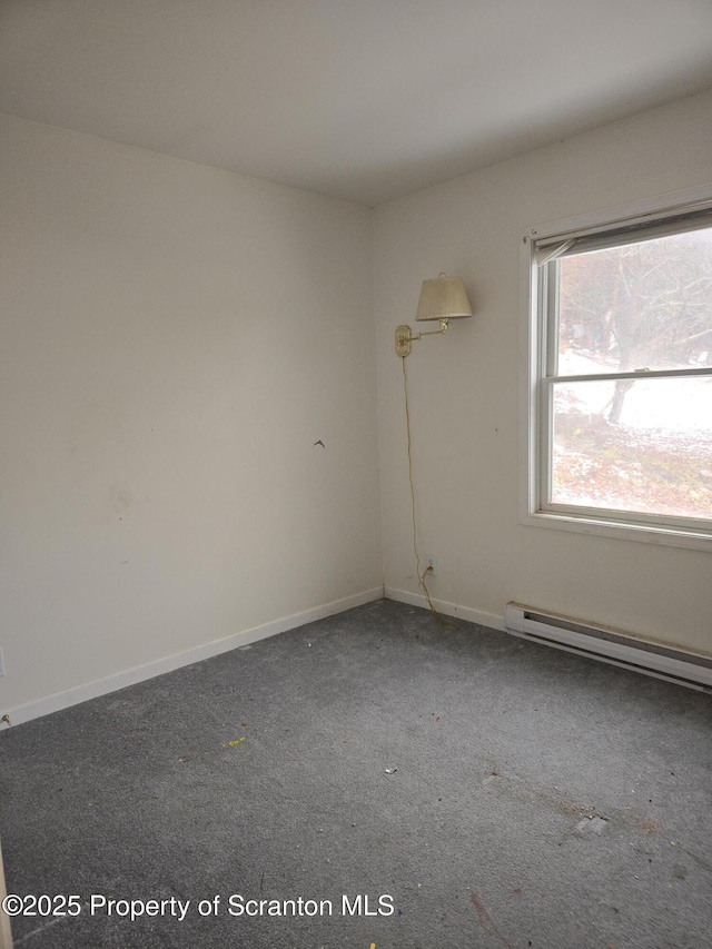 carpeted empty room with baseboards and a baseboard radiator