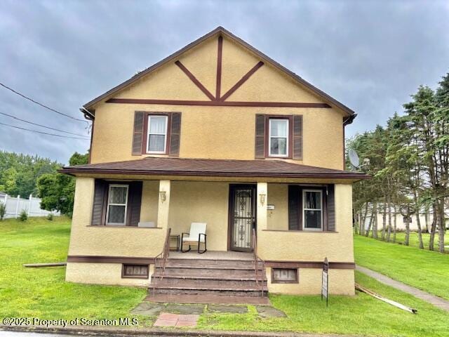 50 Humphrey St Unit 50-51, Old Forge, PA 18518 - view of front of house featuring a porch, stucco siding, and a front yard