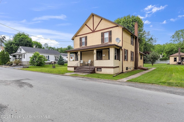50 Humphrey St Unit 50-51, Old Forge, PA 18518 - view of front of home with covered porch, stucco siding, a front yard, and a chimney