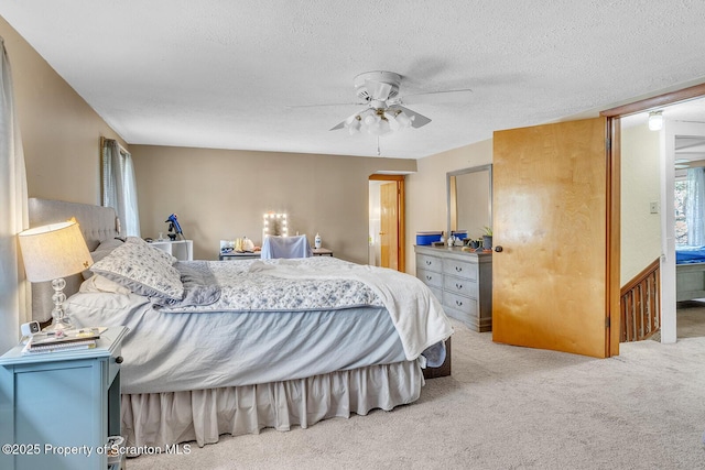 50 Humphrey St Unit 50-51, Old Forge, PA 18518 - bedroom featuring carpet, a textured ceiling, arched walkways, and ceiling fan