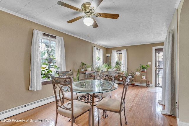 50 Humphrey St Unit 50-51, Old Forge, PA 18518 - dining area with a baseboard heating unit, plenty of natural light, light wood-style floors, and crown molding