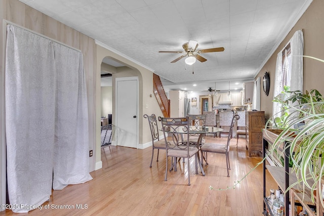 50 Humphrey St Unit 50-51, Old Forge, PA 18518 - dining room featuring ceiling fan, arched walkways, and light wood finished floors