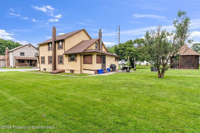 50 Humphrey St Unit 50-51, Old Forge, PA 18518 - back of property featuring a yard and stucco siding