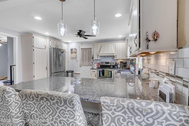 50 Humphrey St Unit 50-51, Old Forge, PA 18518 - kitchen featuring stainless steel appliances, a ceiling fan, premium range hood, a peninsula, and tasteful backsplash