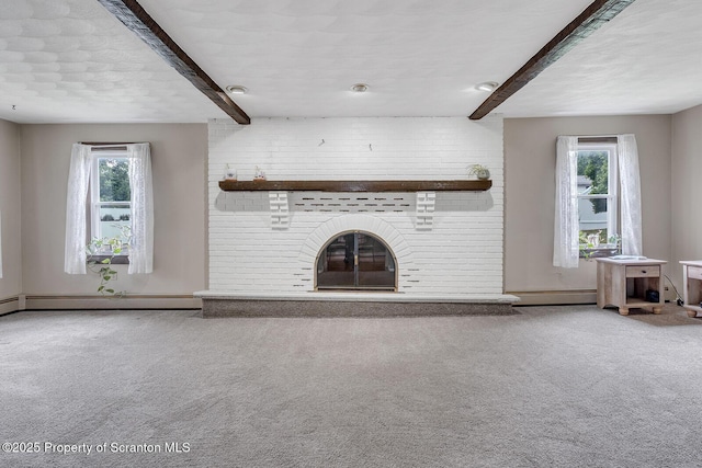 50 Humphrey St Unit 50-51, Old Forge, PA 18518 - unfurnished living room featuring beam ceiling, carpet, healthy amount of natural light, a baseboard radiator, and a brick fireplace