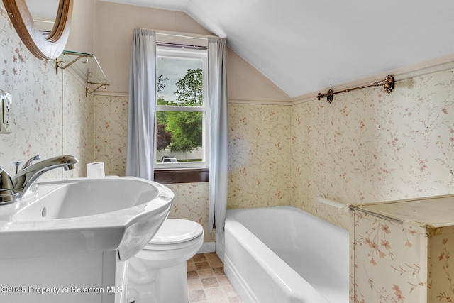 50 Humphrey St Unit 50-51, Old Forge, PA 18518 - bathroom with vaulted ceiling, a tub, and wallpapered walls