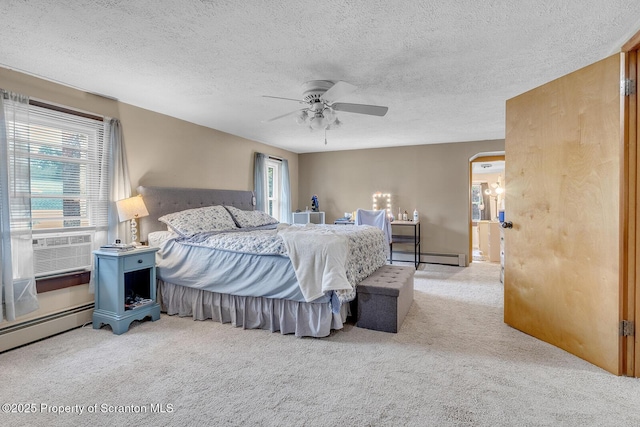 50 Humphrey St Unit 50-51, Old Forge, PA 18518 - carpeted bedroom featuring a baseboard heating unit, a ceiling fan, a textured ceiling, and arched walkways