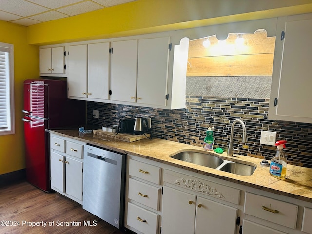 kitchen featuring stainless steel dishwasher, white cabinetry, and sink