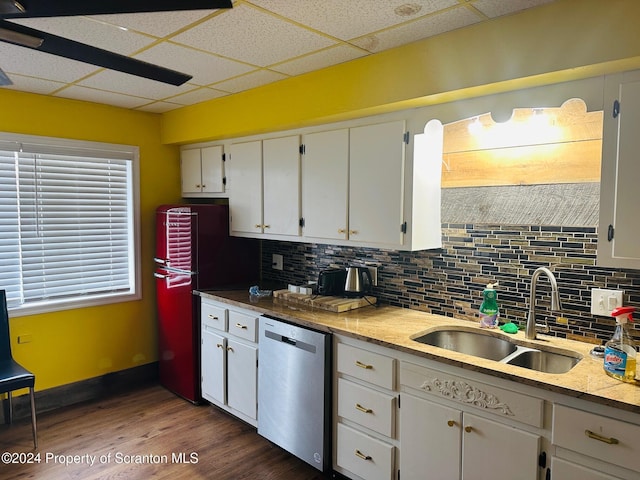 kitchen with white cabinetry, stainless steel dishwasher, tasteful backsplash, and sink