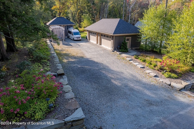 exterior space featuring a garage and an outbuilding