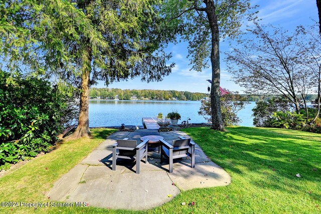 view of yard with a water view and a patio