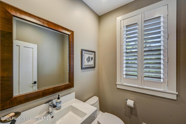 bathroom with toilet and sink