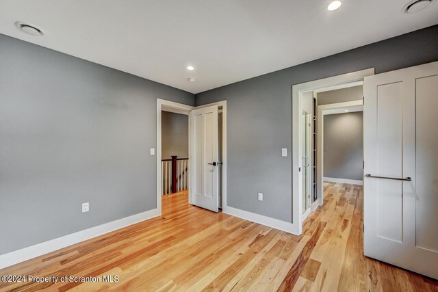 unfurnished bedroom featuring light wood-type flooring