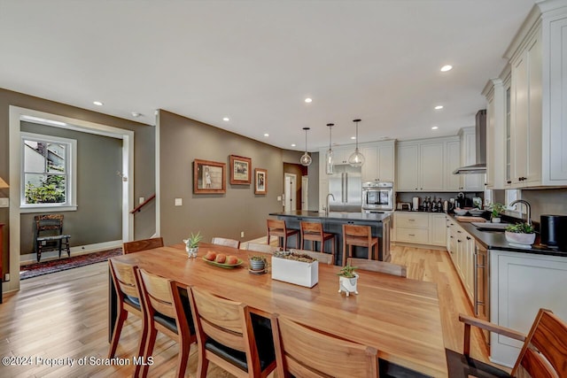 dining space featuring sink and light hardwood / wood-style floors