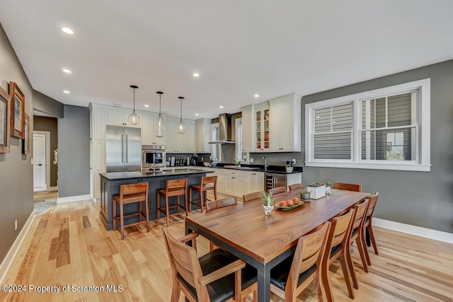 dining space with light hardwood / wood-style floors and sink