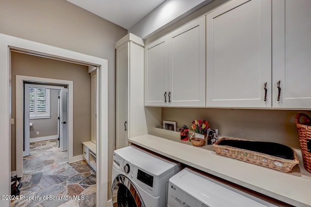 laundry room with cabinets and washing machine and clothes dryer