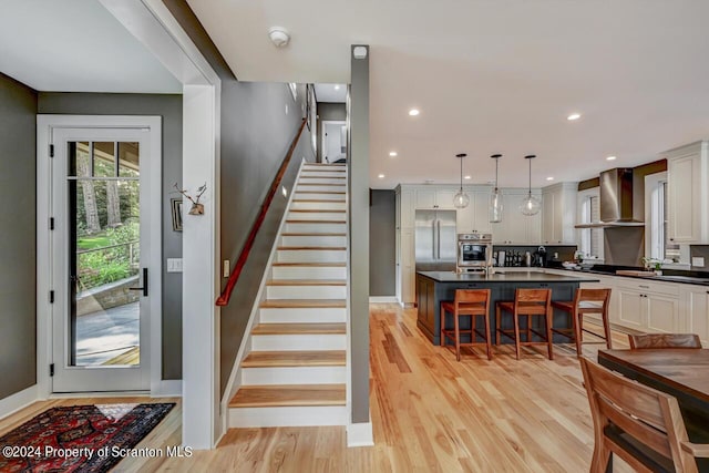 staircase with hardwood / wood-style flooring