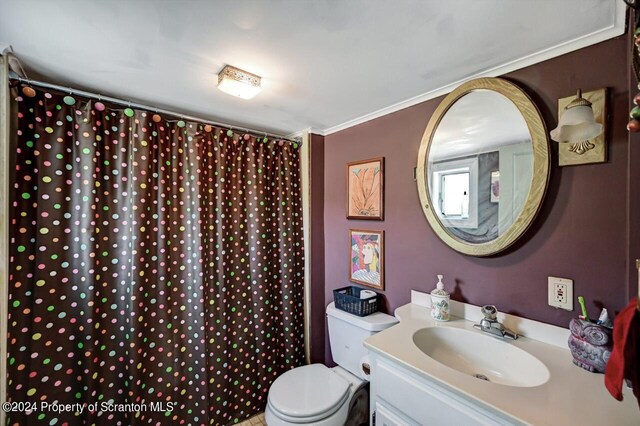 bathroom with vanity, toilet, crown molding, and walk in shower