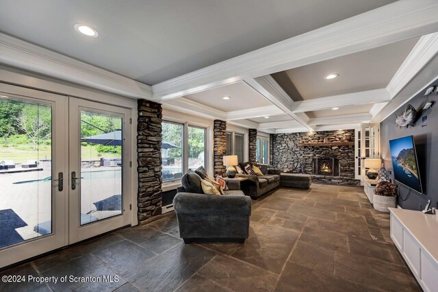 living room featuring beamed ceiling, french doors, a stone fireplace, and coffered ceiling