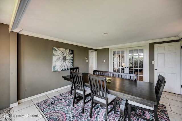 dining room featuring french doors, ornamental molding, and light tile patterned flooring