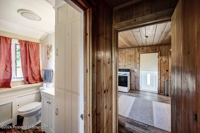 bathroom with wood ceiling, vanity, hardwood / wood-style flooring, toilet, and wood walls