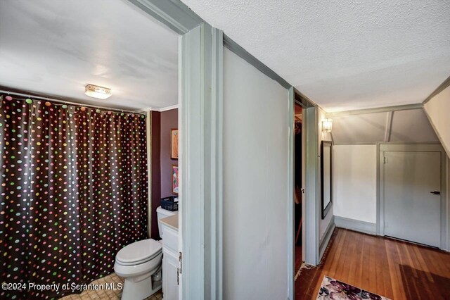 hall featuring hardwood / wood-style floors and a textured ceiling