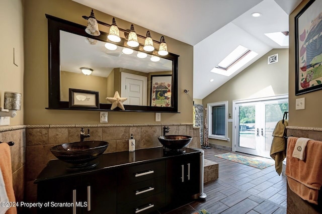 bathroom featuring vanity and lofted ceiling with skylight