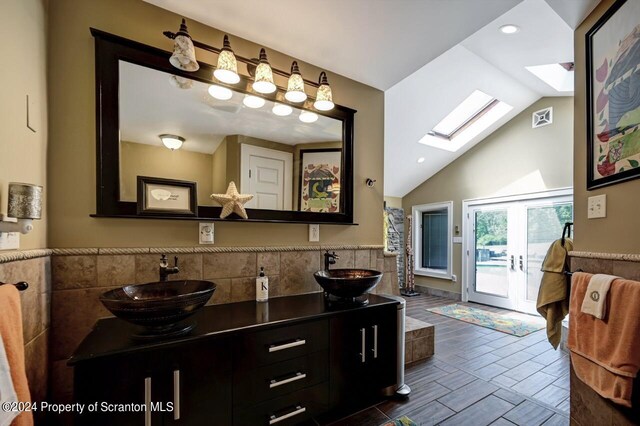 bathroom featuring vanity and lofted ceiling with skylight