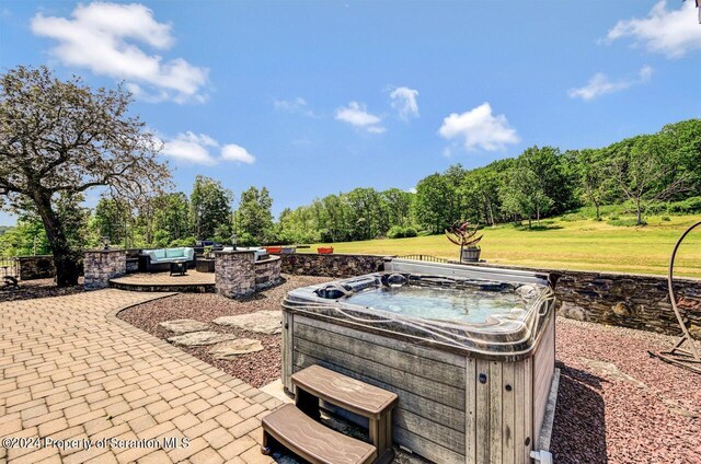 view of patio / terrace featuring an outdoor hangout area and a hot tub