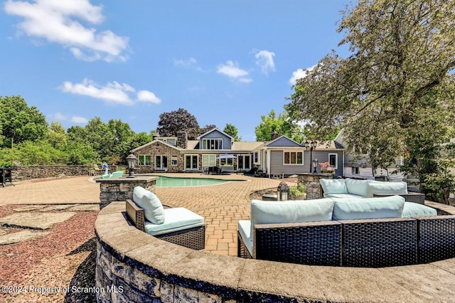 view of pool with an outdoor living space and a patio area