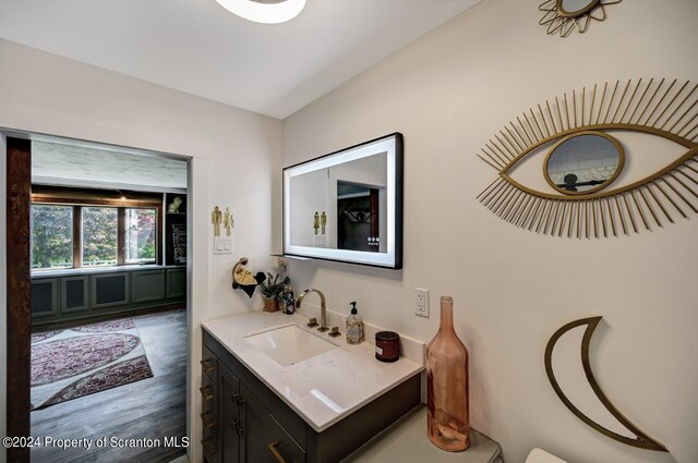 bathroom with vanity and hardwood / wood-style flooring