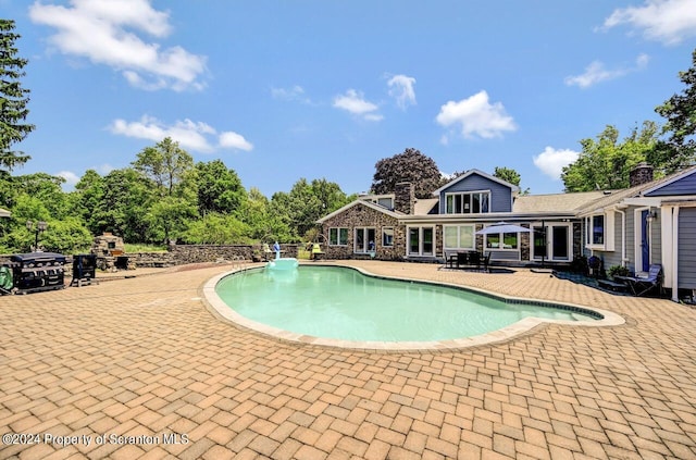 view of swimming pool with a patio area