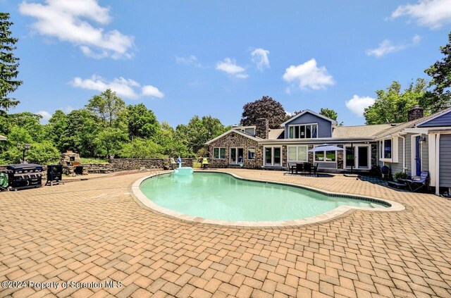 view of swimming pool with a patio area