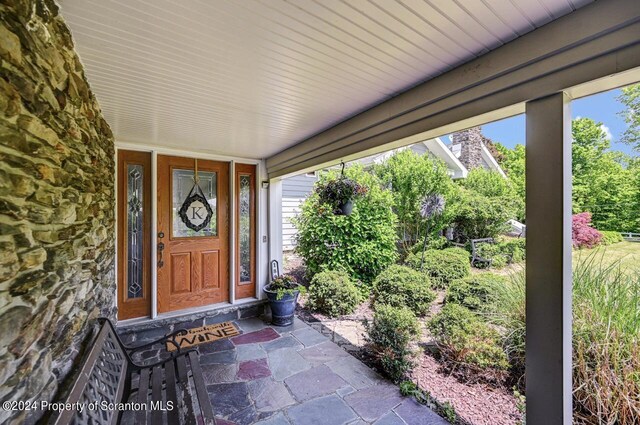 doorway to property featuring covered porch