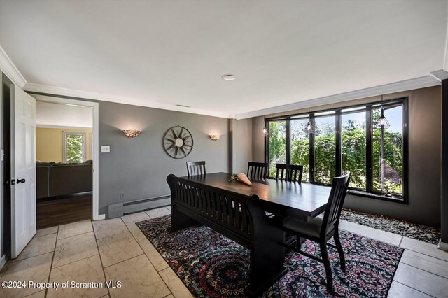 dining space featuring a baseboard radiator and ornamental molding