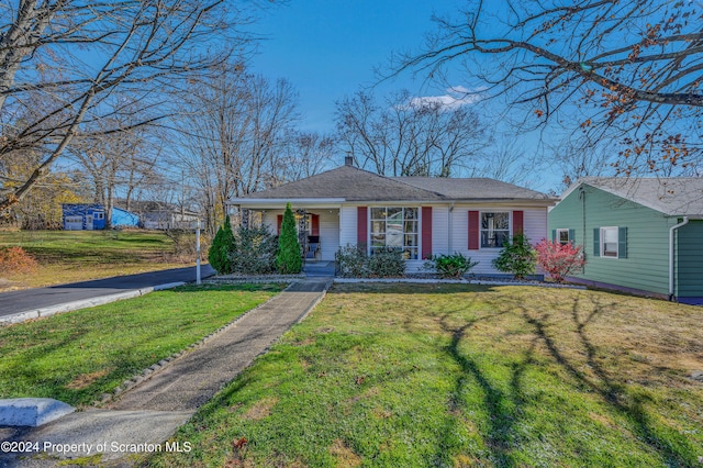 ranch-style house with a porch and a front yard